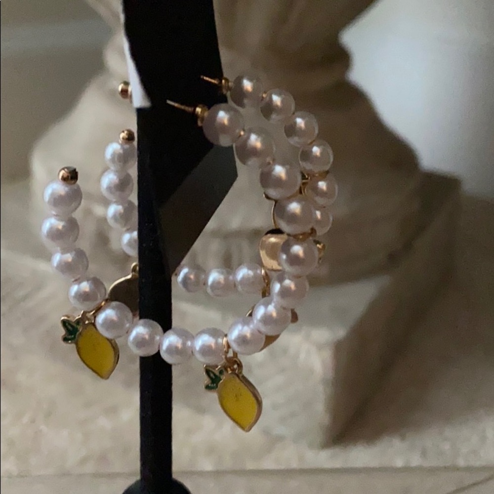 Pearl hoop earrings with pineapple on them